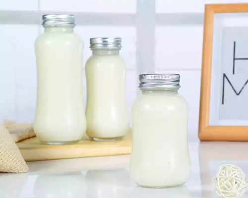 Milk in Glass Bottles With Lids